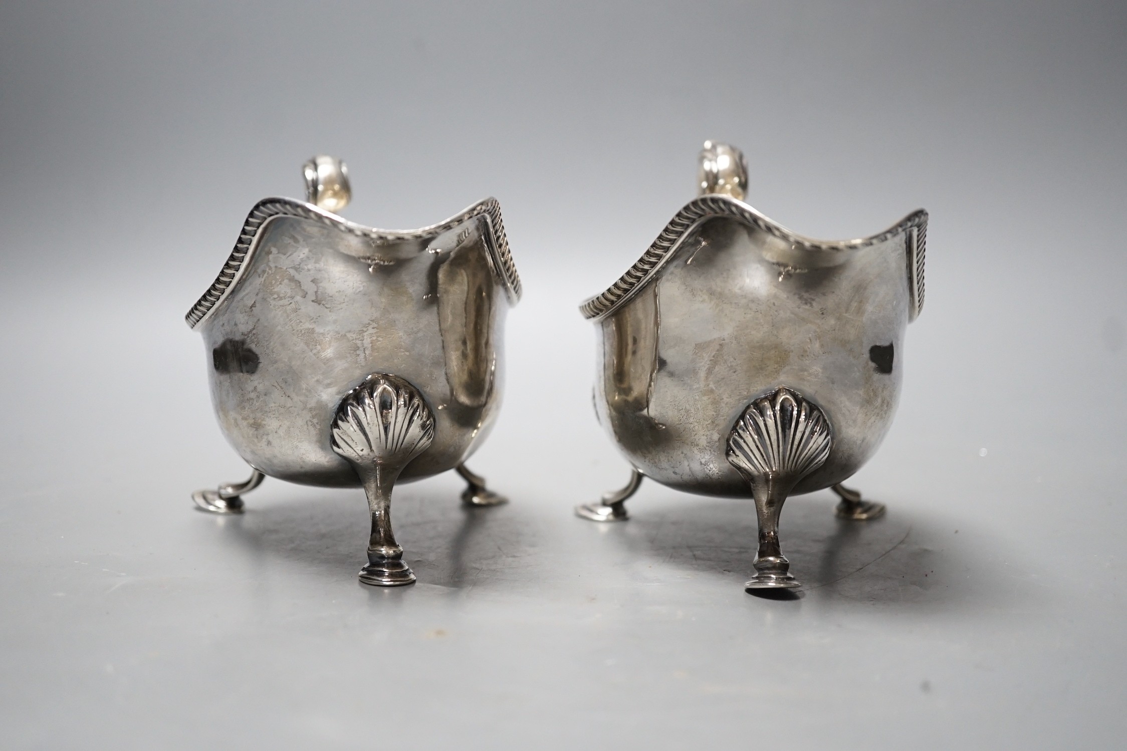 A pair of Edwardian silver sauceboats, with flying scroll handles, Nathan & Hayes, Chester, 1902, 17.7oz.